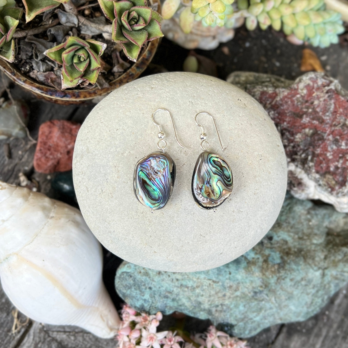 "Coastal Treasures" is a pair of earrings that celebrates the raw and untamed beauty of nature. 