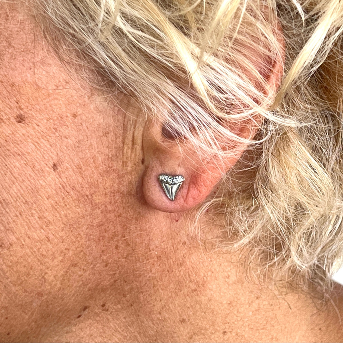These sterling silver shark tooth post earrings are more than just a fashion statement for beach lovers and surfers. They are also amulets of protection, believed to bring good fortune and ward away evil spirits. According to Hawaiian legends, a young warrior wore shark teeth jewelry after diving into the sea and defeating sea gods.