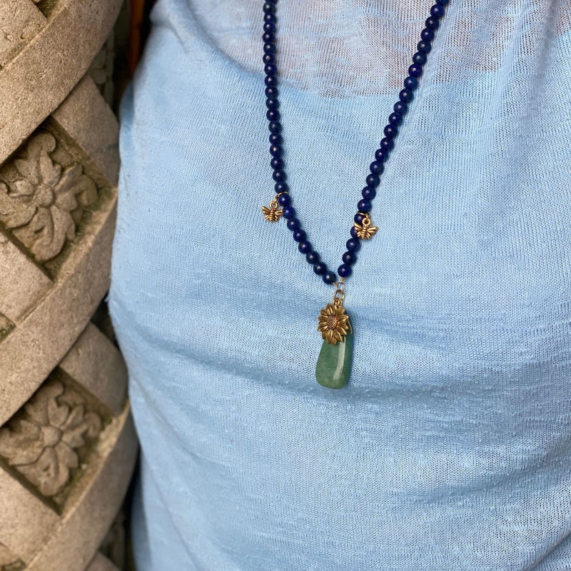 Bee Happy Lapis Lazuli Necklace to Open Your Mind to All Possibilities. The necklace is adorned with playful bee charms and a bright gold sunflower to help you live happy.