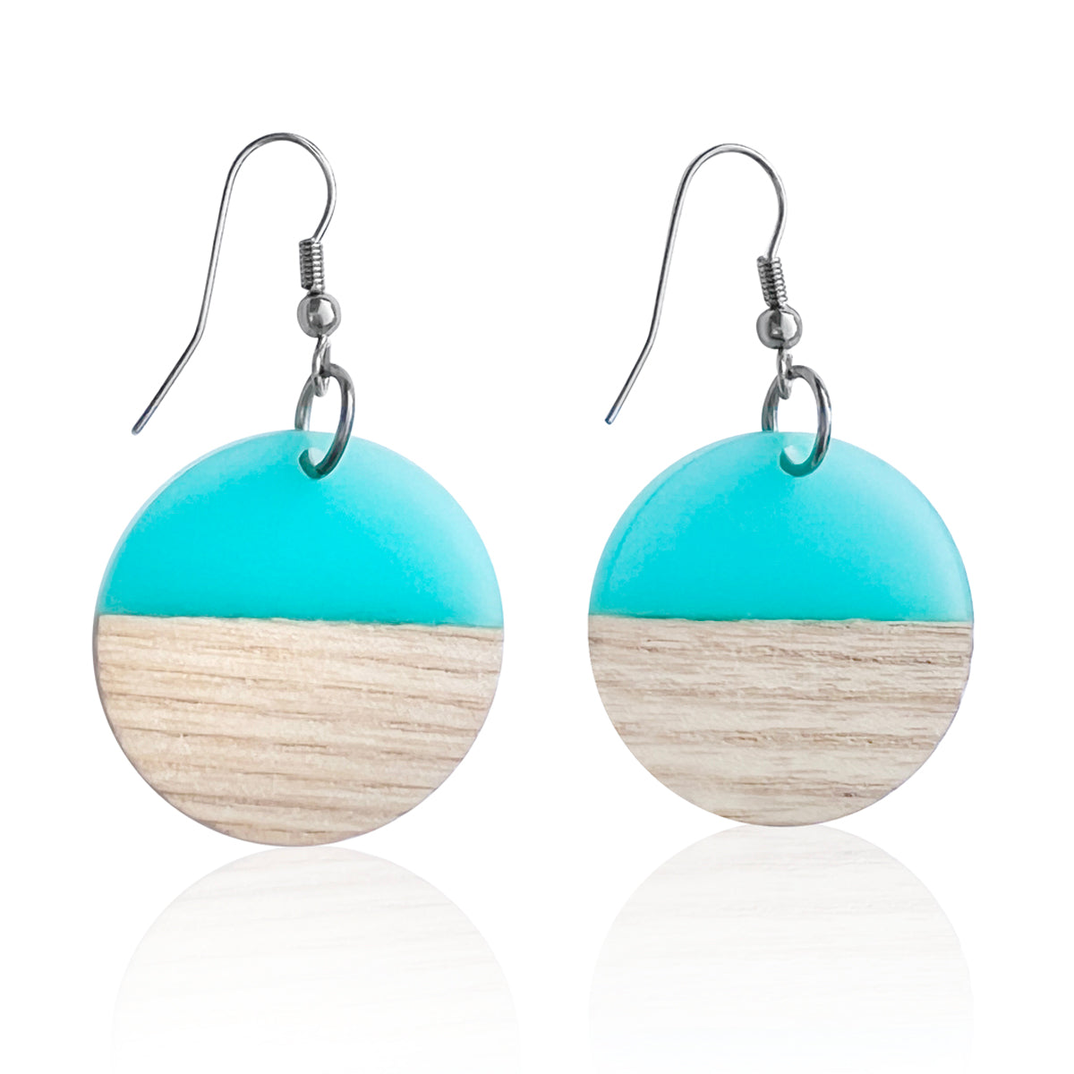 These stunning Coastal Horizon Earrings feature a round pendant made of wood and turquoise blue resin, reminiscent of the sand and ocean. This Coastal Horizon Earrings helps you stay in that Endless Summer mindset all year around. 