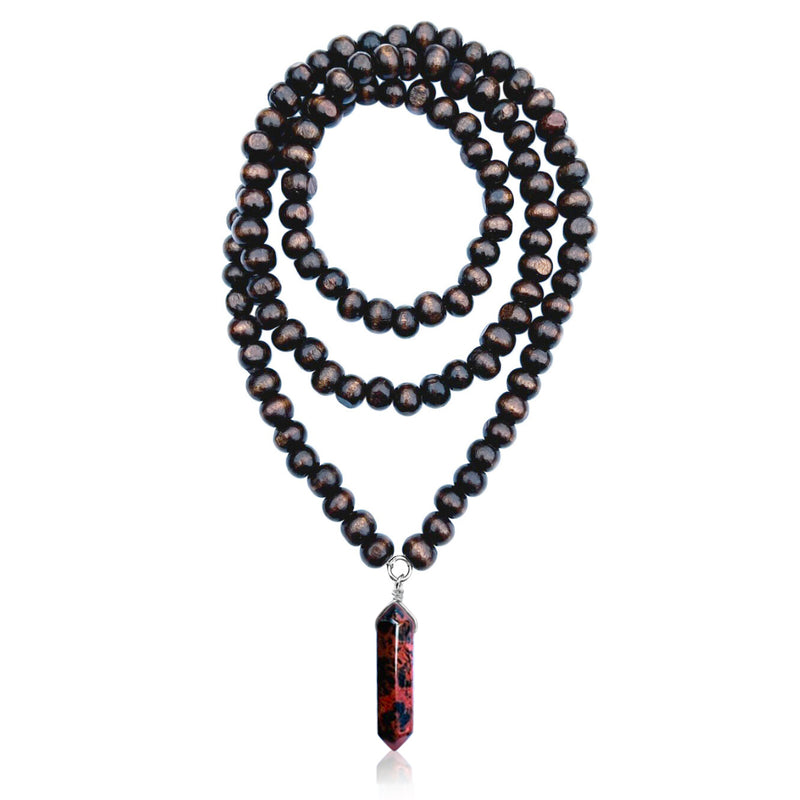 The Fire and Earth  Necklace is a stunning  combination of a wood mala necklace and a polished red and black jasper stone. Jasper is known for its grounding properties, promoting stability and strength.