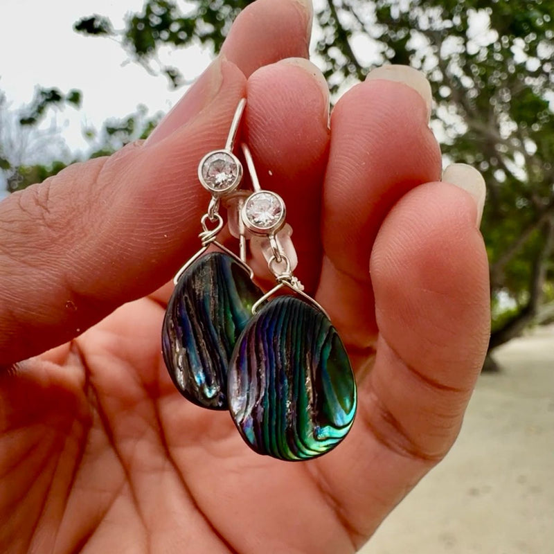 Indulge in the ethereal allure of the Oceanic Dreams Earrings, where the mesmerizing iridescence of the abalone shell transports you to a realm of enchantment.