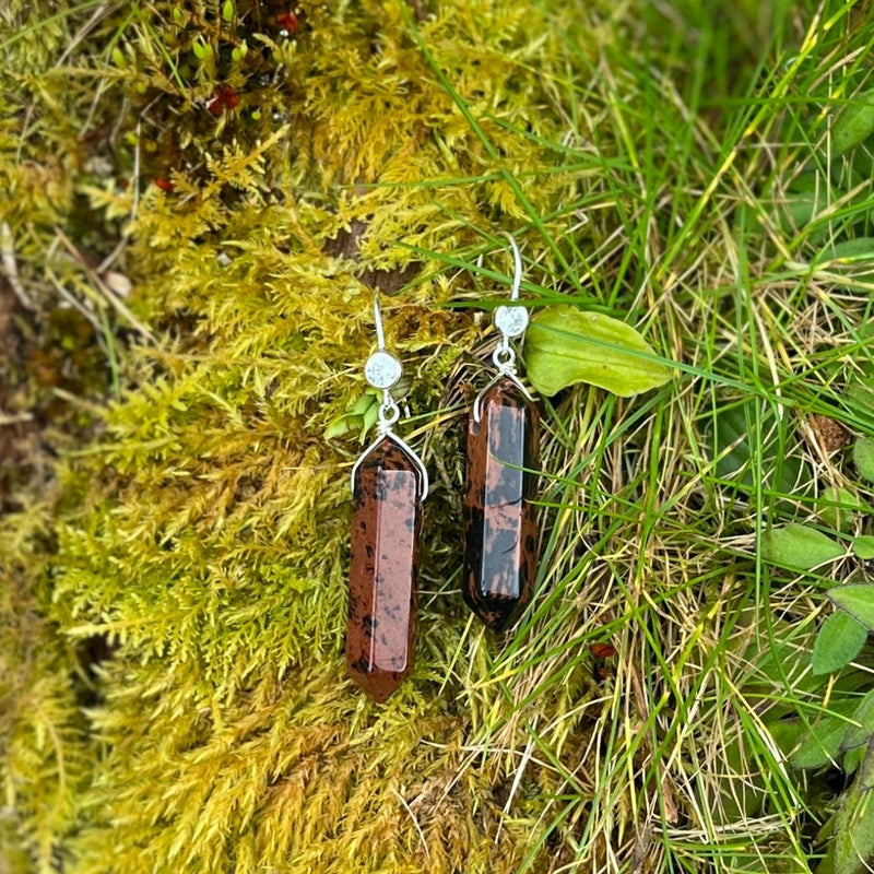 The Fire and Earth Earrings are a stunning pair of earrings that feature two polished red and black jasper stones. Jasper is known for its grounding properties, promoting stability and strength. The combination of red and black jasper creates a bold and powerful energy that is both fiery and grounded.