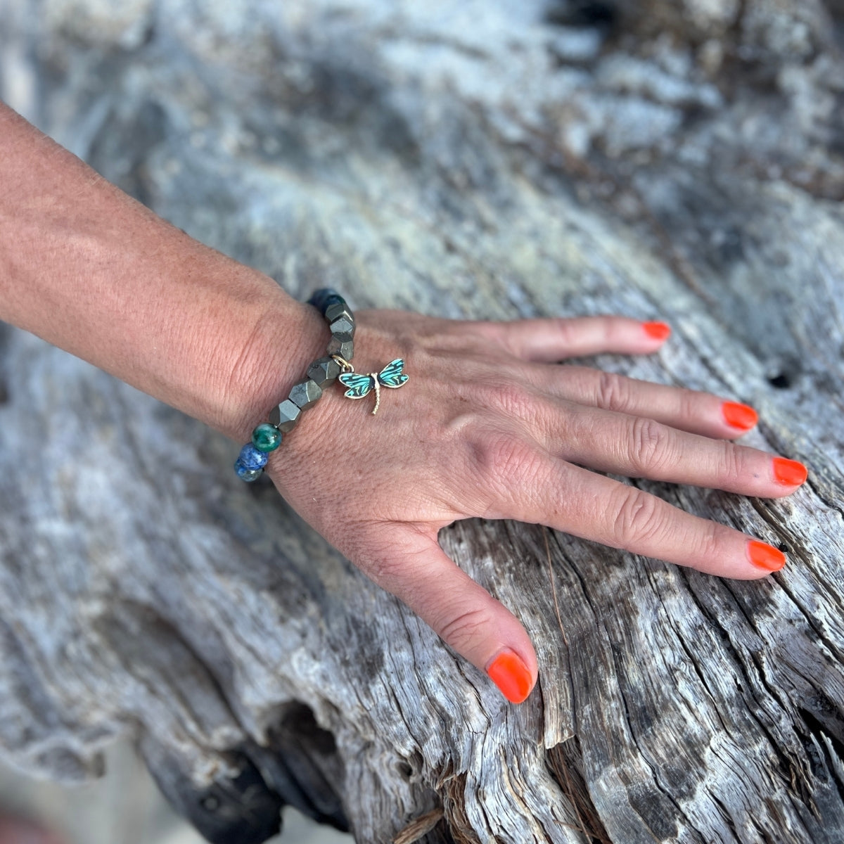 Embrace the harmony of transformation with the Dragonfly Whispers - Chrysocolla and Pyrite Bracelet, a symbol of empowerment and balance, guiding you to navigate life's twists and turns with resilience and grace.