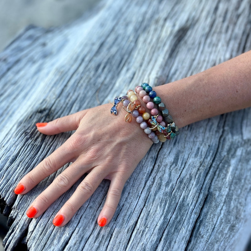 Embrace the harmony of transformation with the Dragonfly Whispers Bracelet Stack, a symbol of empowerment and balance, guiding you to navigate life's twists and turns with resilience and grace.