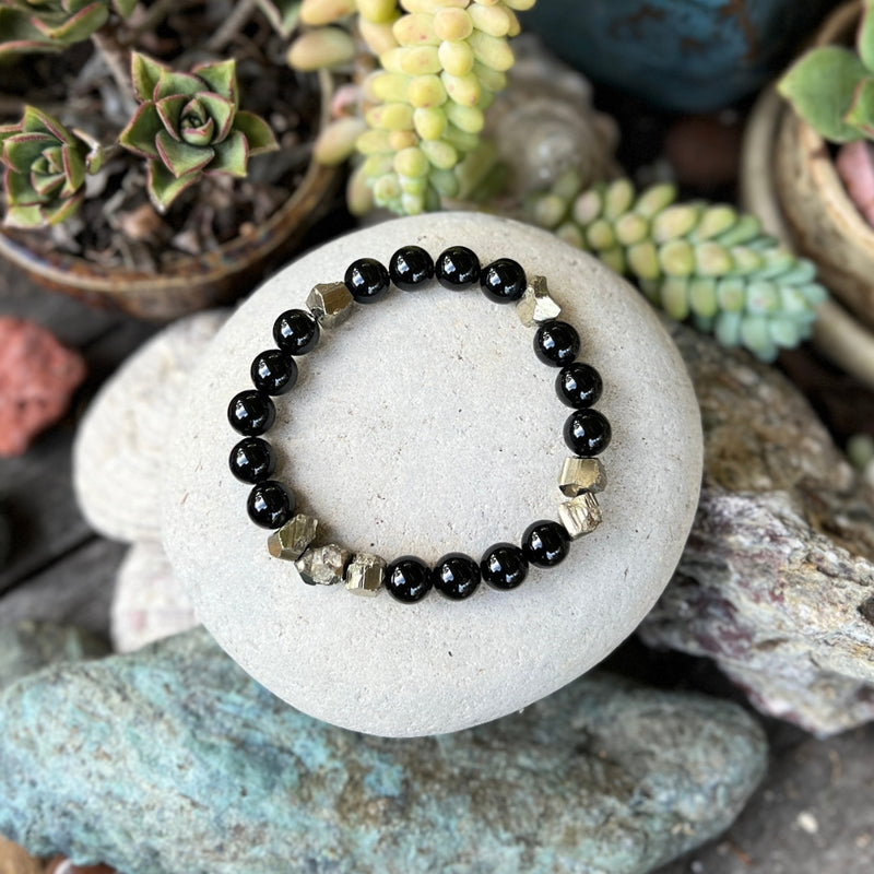 Introducing the "Resilience Surge - Onyx & Pyrite  Bracelet," a mindful fusion of strength, gemstone healing, and style that invites you to embark on a journey of inner fortitude and vibrant living. 