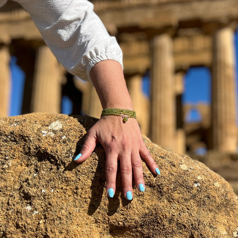 Immerse yourself in the magic of this Peridot Prosperity Wrap Bracelet, as it whispers tales of renewal and abundance, urging you to step boldly into the realm of possibility. 