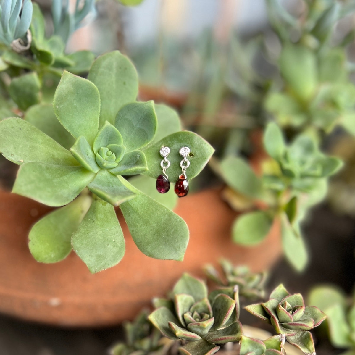 Introducing the captivating Petite Sparkle - Garnet Earrings, thoughtfully crafted for individuals who resonate with a free-spirited lifestyle, seek crystal healing, and desire the invigorating energy of Garnet.