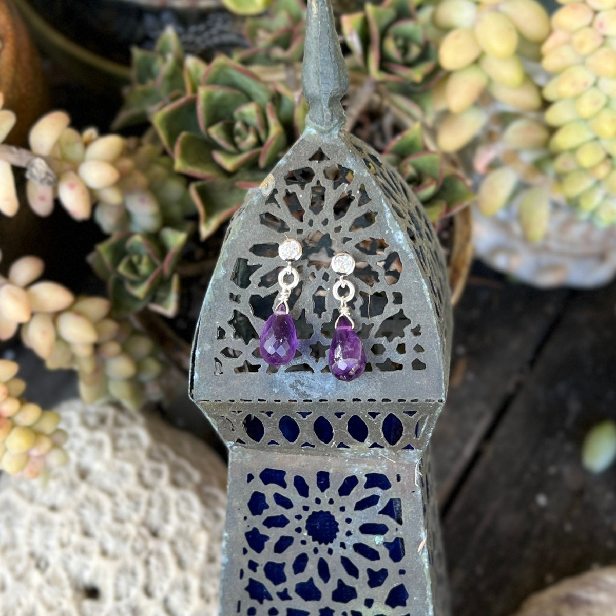 The enchanting Petite Sparkle - Amethyst Earrings designed for free-spirited individuals with a penchant for crystal healing and positive vibes, these earrings are a testament to both elegance and spiritual connection.