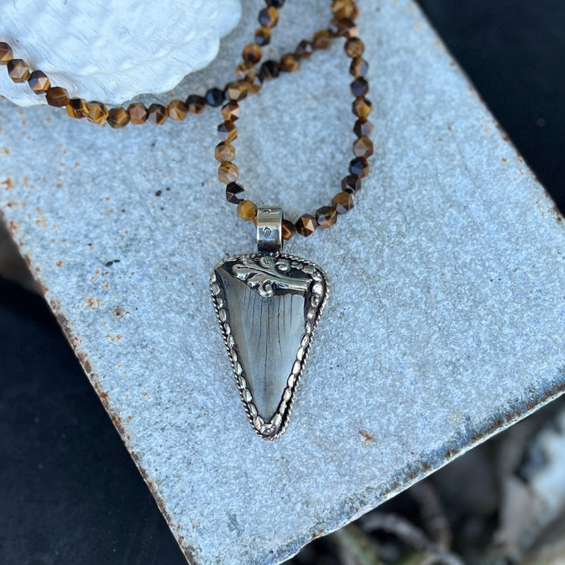 This Megalodon Shark Tooth Necklace is for the adrenaline hunters and shark lovers—anyone who understands that apex predators don't apologize for their power.