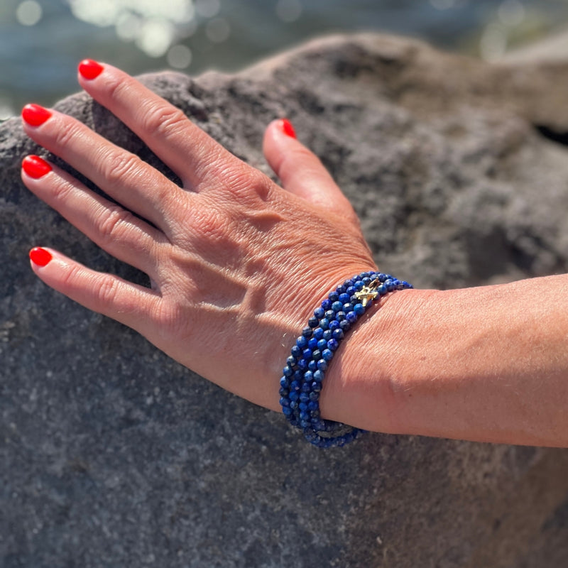 The Ocean Treasures Wrap Bracelet features stunning blue Lapis Lazuli stones that evoke the calming and peaceful essence of the ocean. Adding to the charm of the bracelet is the tiny gold dipped Shark Tooth charm. The Shark Tooth is a symbol of strength and resilience. Perfect for the Adrenaline Hunters and Shark Lovers