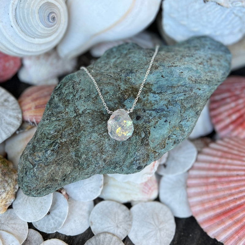 The Your Vibration is Rising Necklace features a Titanium coated raw Moonstone nugget, radiating ethereal energy to elevate your spiritual frequency and awaken your inner light.