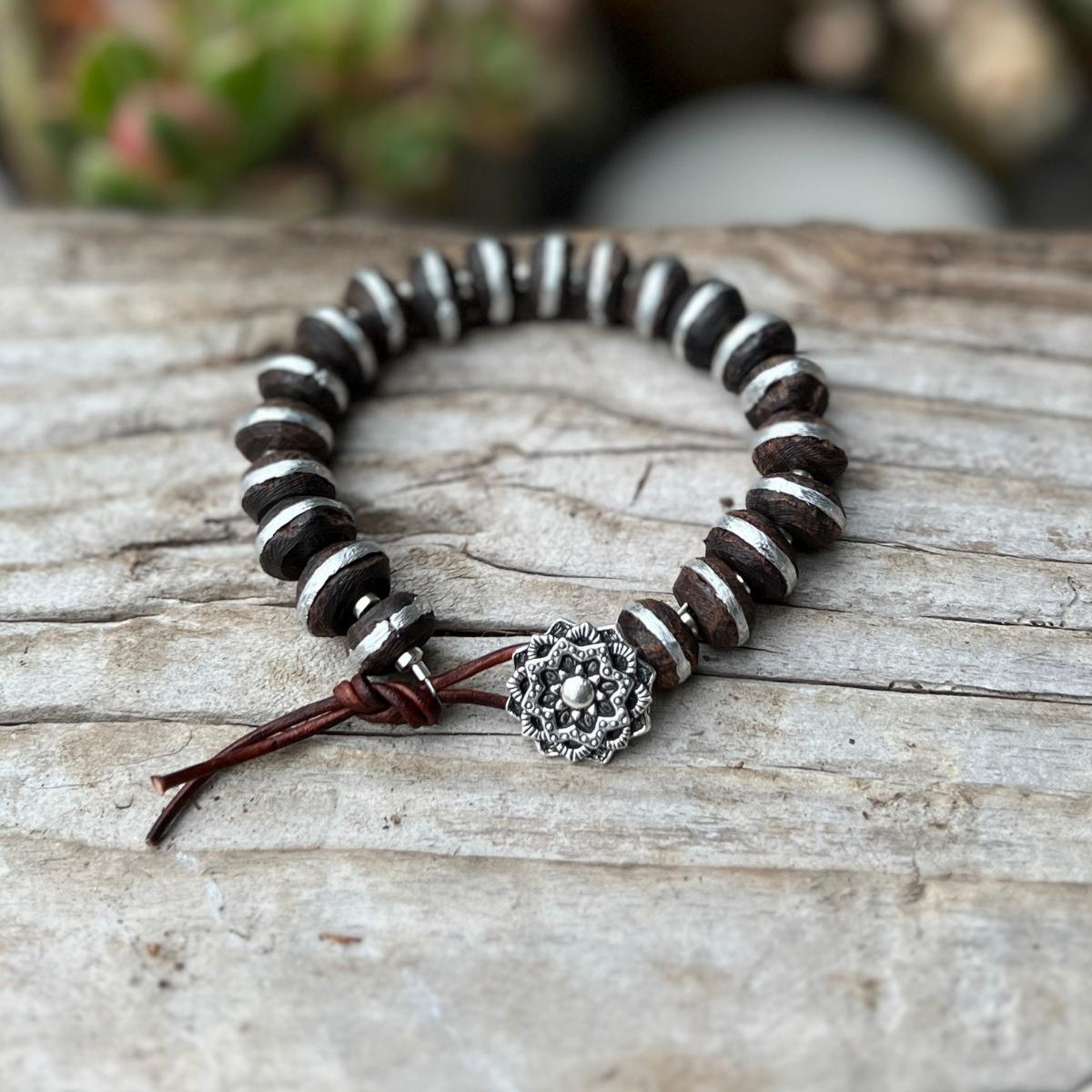 The "Ebony Tranquility Mandala Bracelet" is a striking accessory crafted for both men and women who appreciate substantial, larger pieces that seamlessly blend elegance with the meaningful symbolism of the mandala.