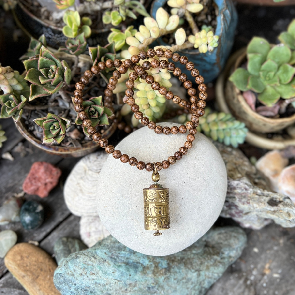Experience the divine synergy of spirituality and style with our "Prayer Wheel - Wood Necklace for Many Blessings." May it bring you a sense of tranquility and invite countless blessings into your life's journey.