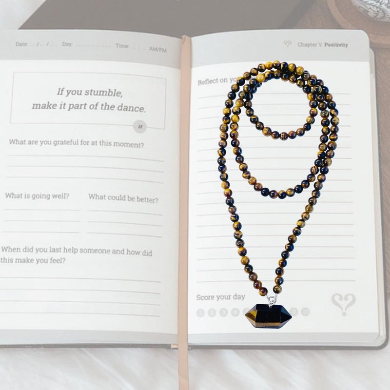 Journal now with the #1 best-selling guided journal and experience a breakthrough in relationships, your mental well-being and an increased sense of togetherness and belonging in the world.  Work on your gratitude journal while wearing the Unisex Tiger Eye Grounding Necklace for Balance and Strength.