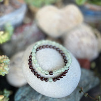 This healing gemstone bracelet pair will have you two lovestruck in a grounded Earthy way.  Spoil yourself and your love with these TWOgether Bracelets! Garnet and Prehnite Bracelet Pair 🖤 🤍 for those couples who prefer less bling and more mindfulness in their lives.    Say "I love you" with this healing gemstone bracelet pair. It connects you two in a special bond.📿❤️