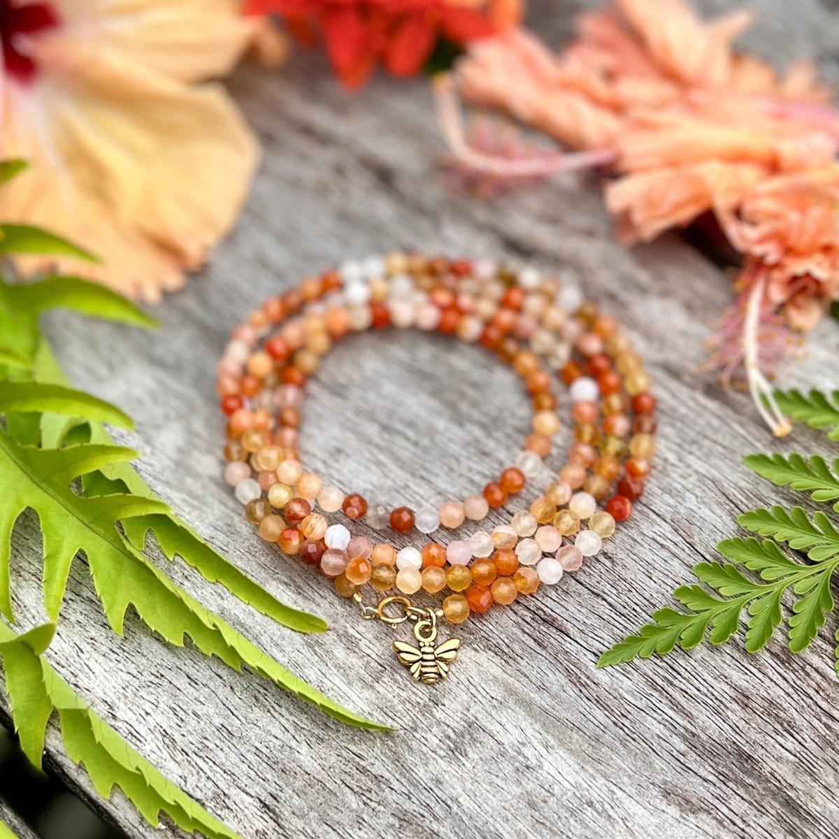 Bee Happy Wrap Bracelet with colorful Jade and Carnelian. The bracelet is adorned with a playful bee charm to help you live happy.