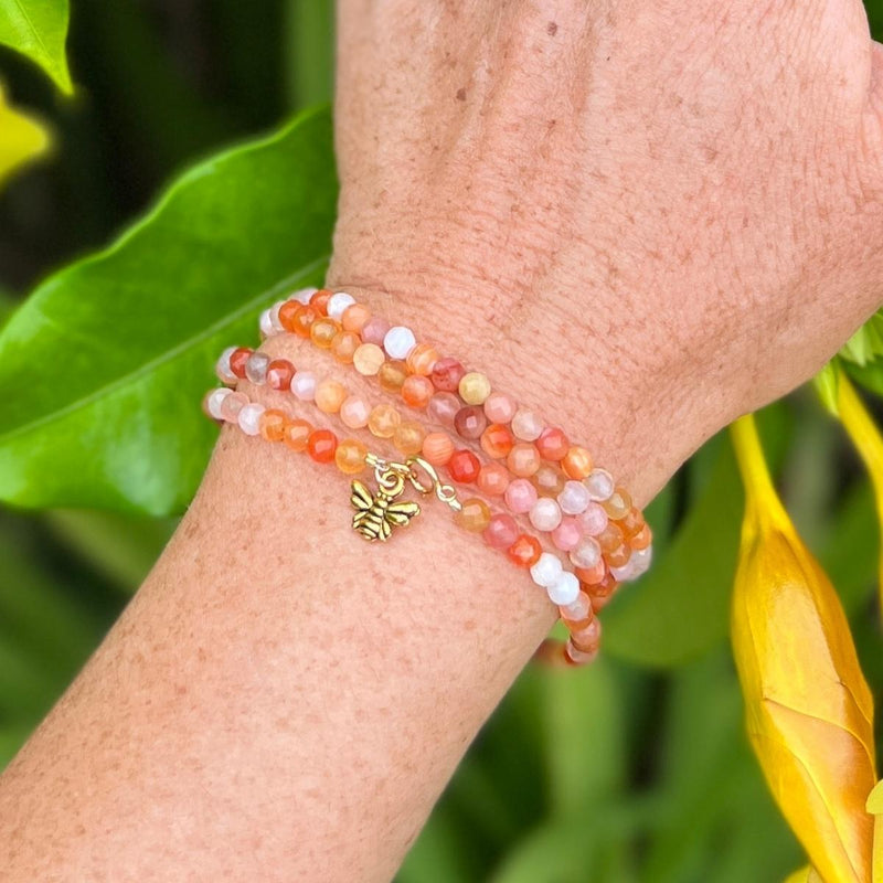 Bee Happy Wrap Bracelet with colorful Jade and Carnelian. The bracelet is adorned with a playful bee charm to help you live happy.