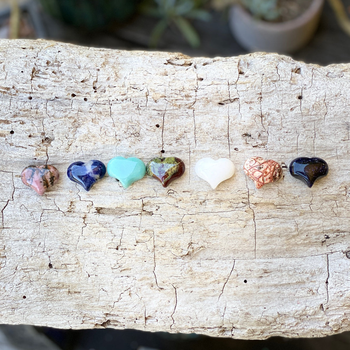 Unique and genuine heart shaped gemstones. Set of 7 chakra stones, Metaphysical Crystals that help you connect with your chakras. This set includes  the following 7 heart shaped gemstones:  Rhodonite, Sodalite, Amazonite, Dragon Blood, White Jade, Leopard Jasper, Purple-Blue Golden Sandstone.