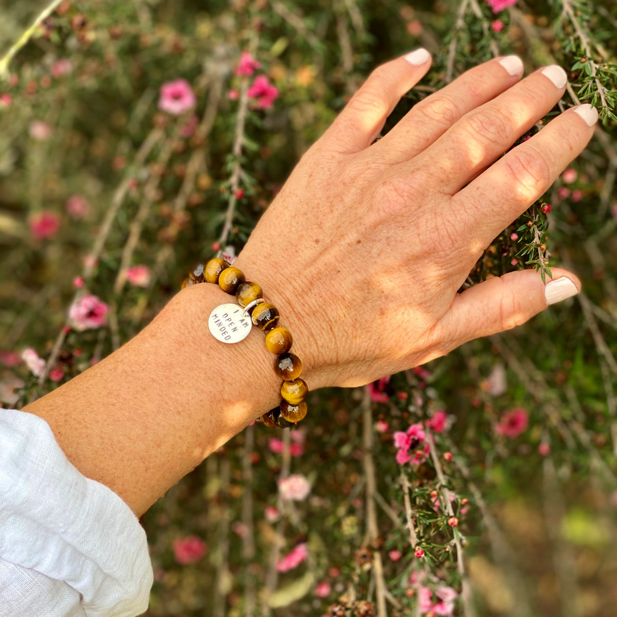 I am Open Minded Affirmation Bracelet with Tiger Eye to See Both Sides of an Argument. There are many ways to see the same situation. Rather than automatically searching for flaws, open your mind (and heart) and seek out the positive aspects of what's going on, or at least another perspective. 