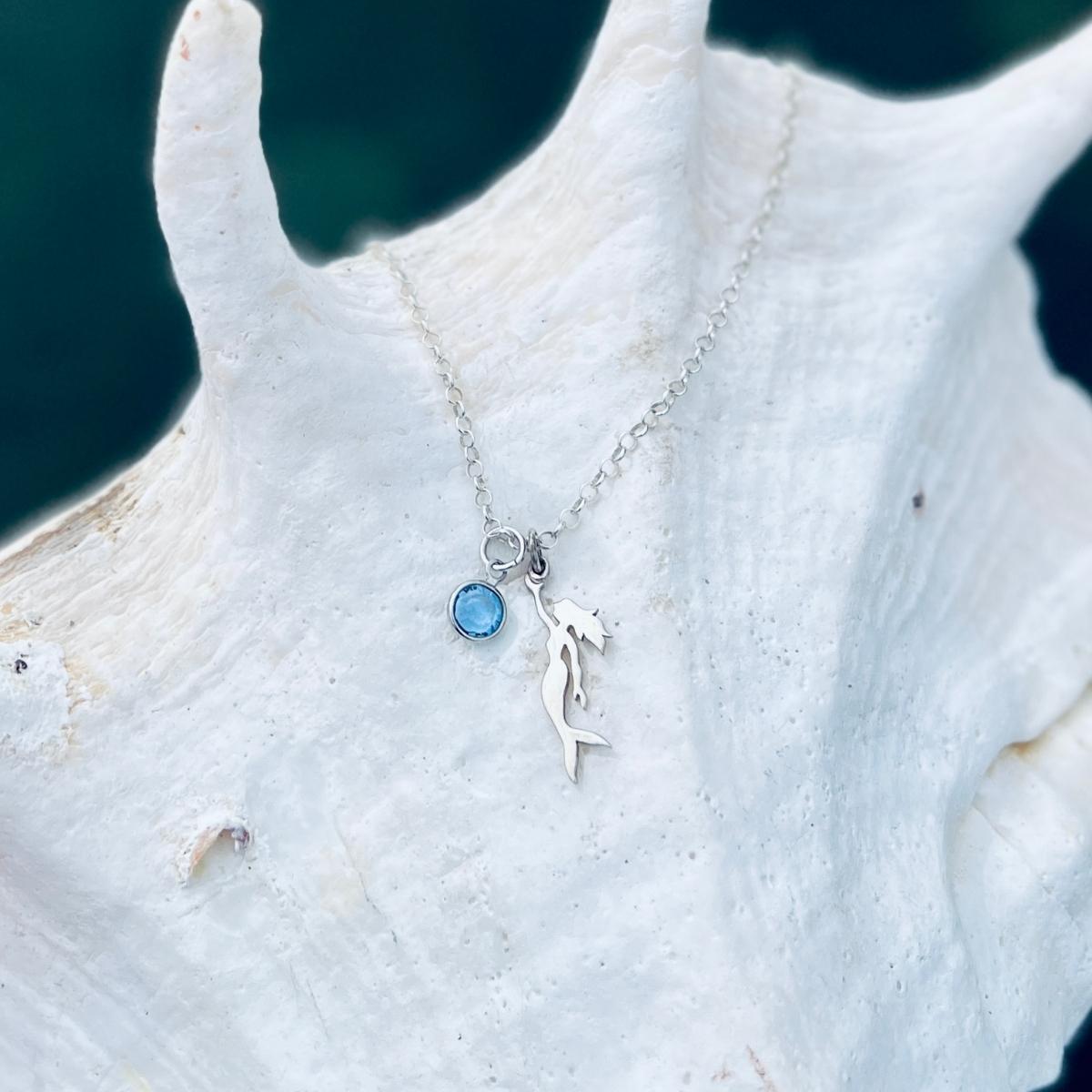 Sterling Silver Miss Scuba Mermaid Necklace with Swarovski Crystal This piece reflects Miss Scuba's sense of mystery and individuality, and beckons the free spirit in every self-made women.  Mermaids symbolize Love, Beauty, Mystery, Untamed Spirit and Femininity.