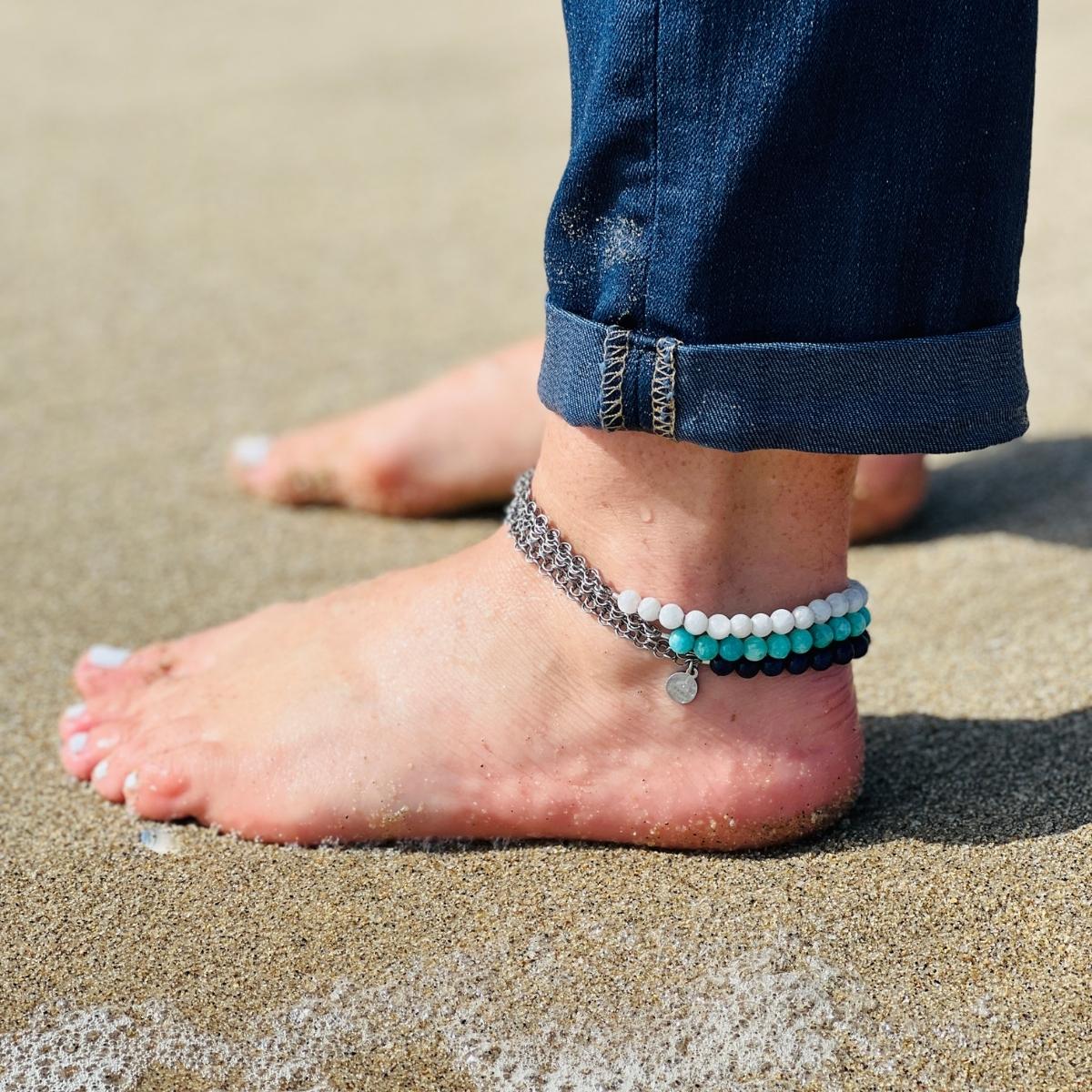 Neptunic SharkSuit Anklet - Sustainable Fashion for Ocean Lovers. Amazonite empowers one to search the self and discover one’s own truths and integrity, and to move beyond fear of judgment. Wear this crystal healing anklet and feel the empowering energies every step you take!