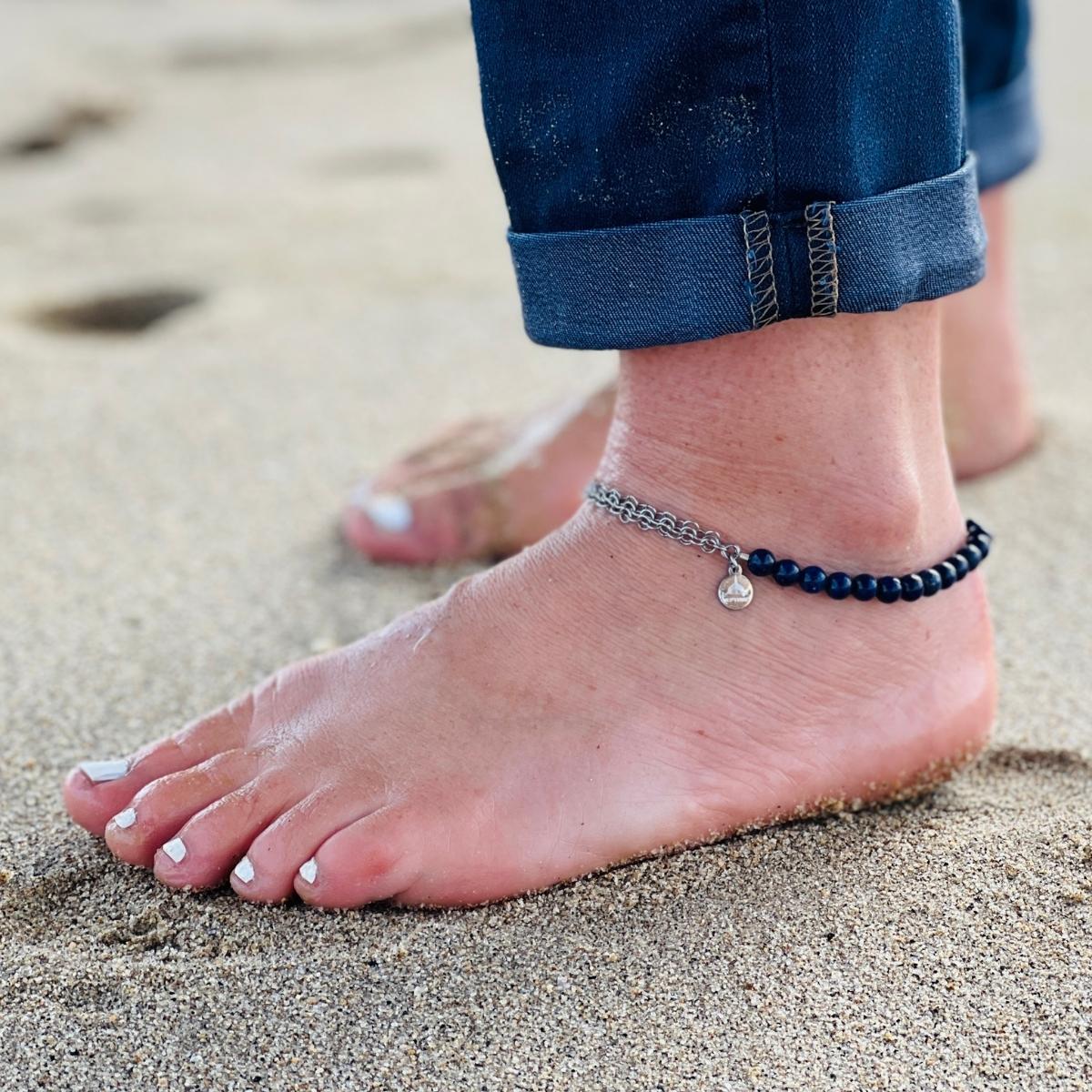 Neptunic SharkSuit Anklet - Sustainable Fashion for Ocean Lovers. People of the Water is dedicated to changing people's relationship with our aquatic world through Exploration, Education, and Conservation. Portions of the sale of this jewelry supports the People of the Water Non-Profit. 