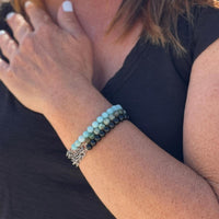 Neptunic SharkSuit Bracelet Stack with African Turquoise, Amazonite and Onyx - Sustainable Fashion for Ocean Lovers. Neptunic loved Szilvia Gogh's Zero Waste Project (upcycled jewelry made of used scuba gear) parts and asked her to repurpose their chainmail accumulated during Sharksuit fabrication, into gorgeous pieces of handcrafted sustainable jewelry. 