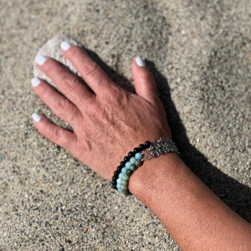 Neptunic SharkSuit Bracelet Stack with African Turquoise, Amazonite and Onyx - Sustainable Fashion for Ocean Lovers. Neptunic loved Szilvia Gogh's Zero Waste Project (upcycled jewelry made of used scuba gear) parts and asked her to repurpose their chainmail accumulated during Sharksuit fabrication, into gorgeous pieces of handcrafted sustainable jewelry. 