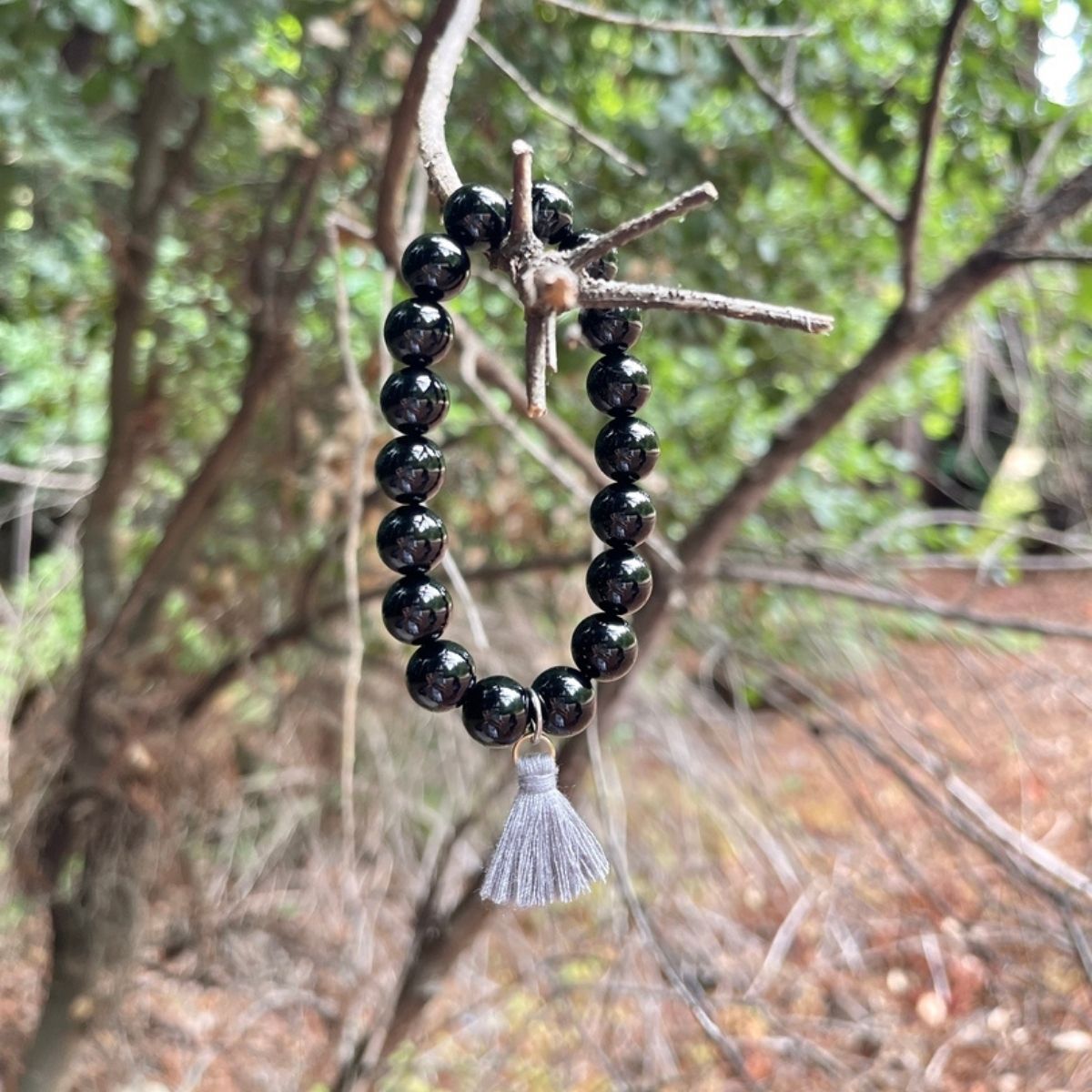 Onyx Bracelet with Tassle to Remind Us that Our Shadows are Parts of Us. Unisex Black Onyx Bracelet for Self-Control. Onyx helps one have self-control and anchors one’s flighty energy. Black, usually a color of “darkness” Onyx remind wearers that shadows are parts of us, and that we ALL have them.