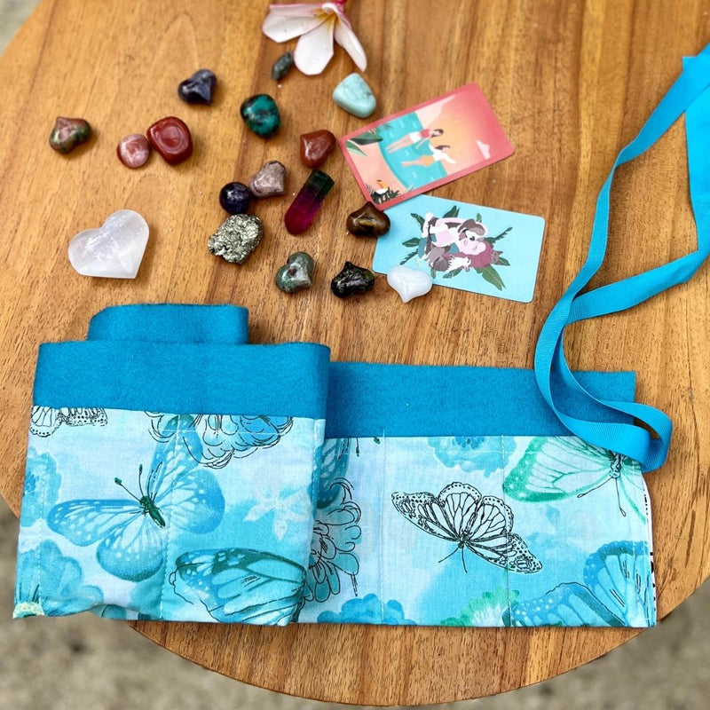 The Radical Self Love Mindset Crystal Grid Set is a comprehensive self-care kit that includes healing gemstones, self-care meditation cards, and a handmade roll-up travel case, designed to promote self-love, inner peace, and positive energy.