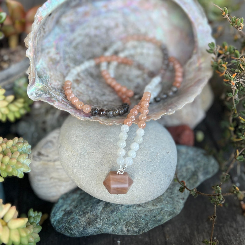 The Sun and Moon in Balance Necklace. The Sun emerges the constant, Masculine, Original Source of Mind and Spirit from which all life emanates. The Moon is an expression of the reflection of Mother Earth and feminine nature. They need each other to be in balance, much like Yin and Yang.