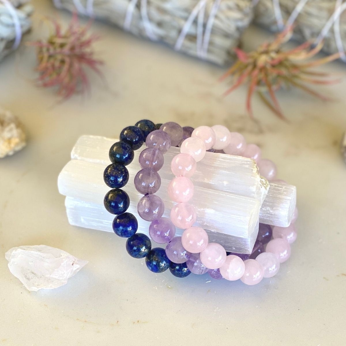 Trauma Healing Bracelet Stack. What is trauma? Look it up in the dictionary, and you’ll find that it’s “a deeply distressing or disturbing experience.” And you know what? It’s painfully common. Wear this bracelet stack to assist you on your trauma healing journey!